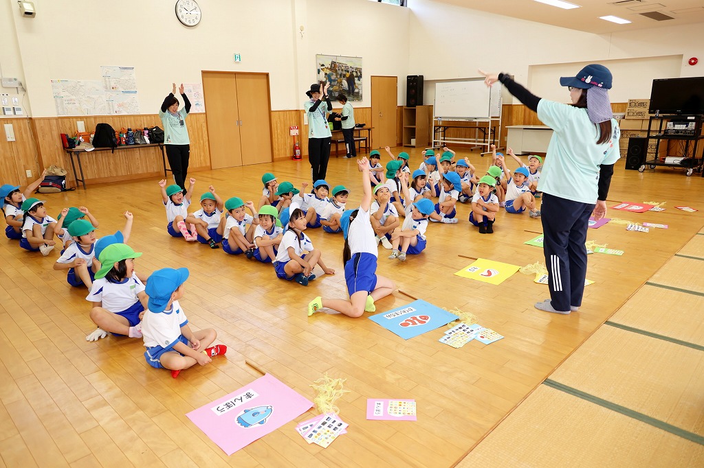 園児たちが探検グループごとに座り、先生の話を聞いている様子