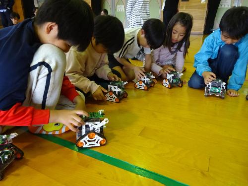 小学生プログラミング教室で車輪型ロボットを動かす子どもの様子